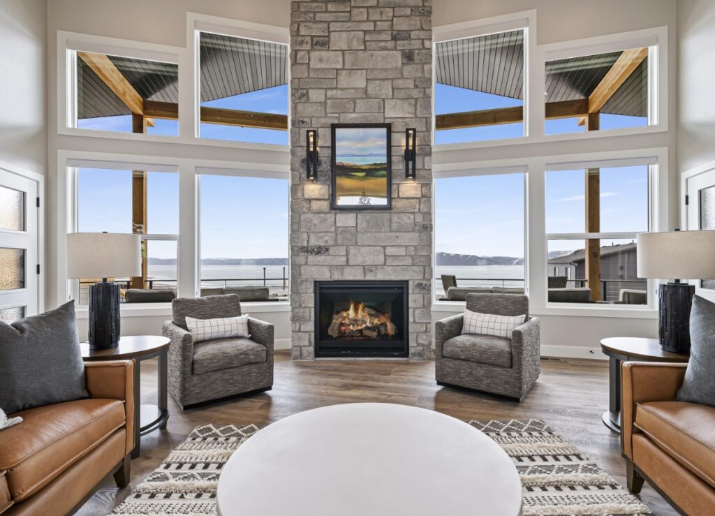 Image of Highland Chateau family room with a lit fire in the fireplace overlooking Bear Lake, a beautiful setting for hosting a corporate event.