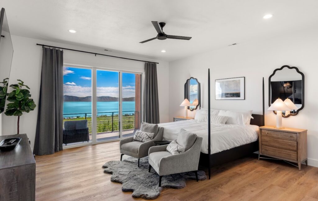 Image of a bedroom with a lake view of Bear Lake through the window.