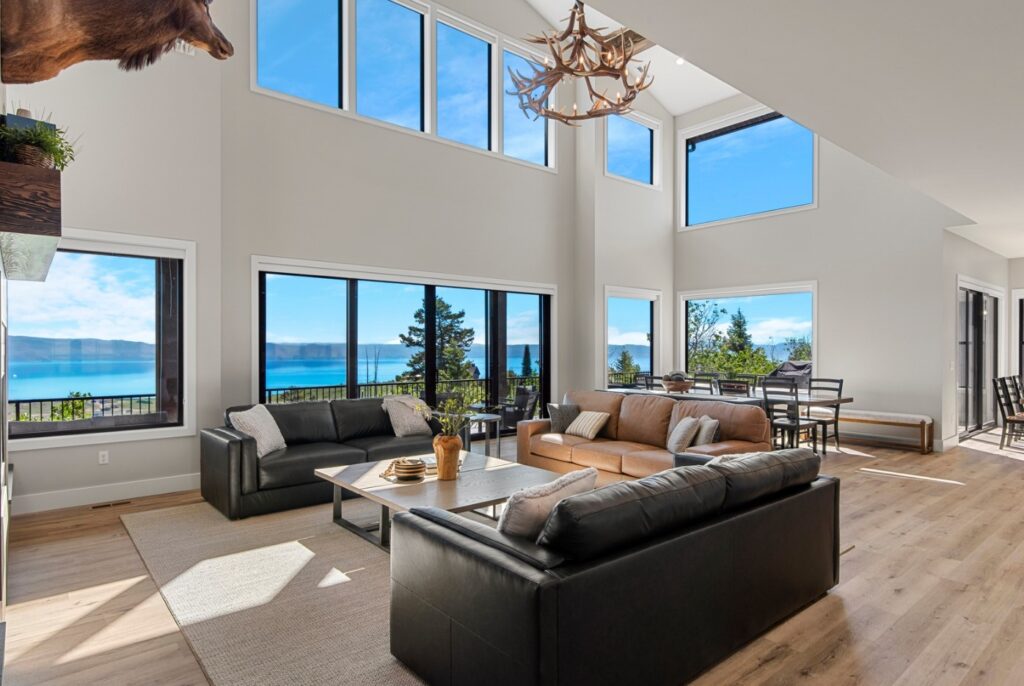 100 Acre Lodge family room, open to above, overlooking the blue waters of Bear Lake.