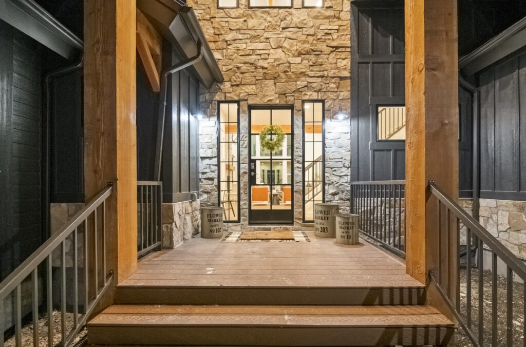 Front entrance to Black Timber Lodge showcasing craftsman style building with stone and board and batten.