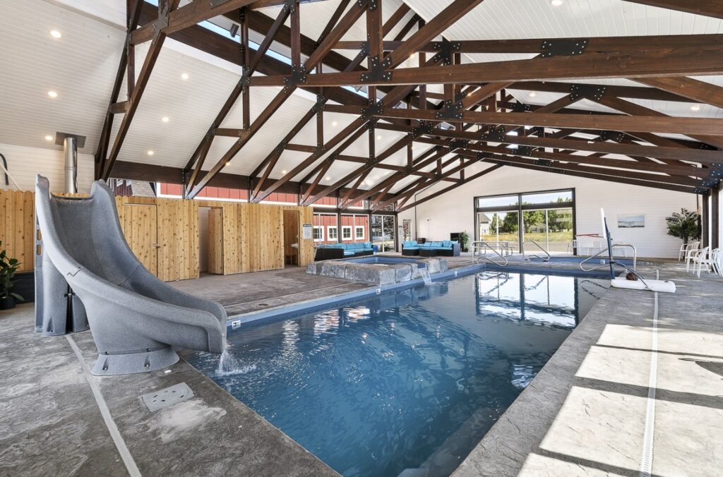 Indoor pool with waterslide and spillover hot tub, perfect for a winter wellness retreat at Bear Lake.