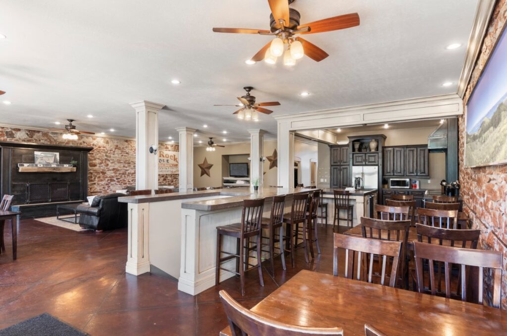 Open concept living room and kitchen with exposed brick walls.