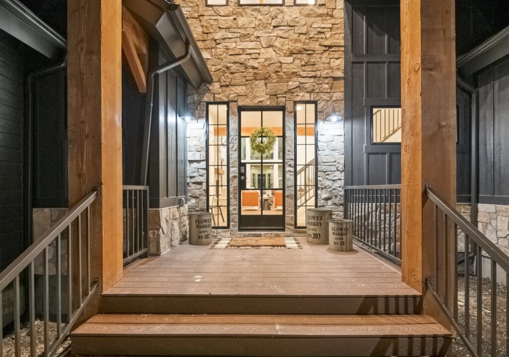 Black Timber lodge's front door, decorated with a wreath.